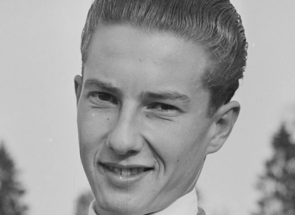 Black and white close-up of a young Lester Piggott smiling