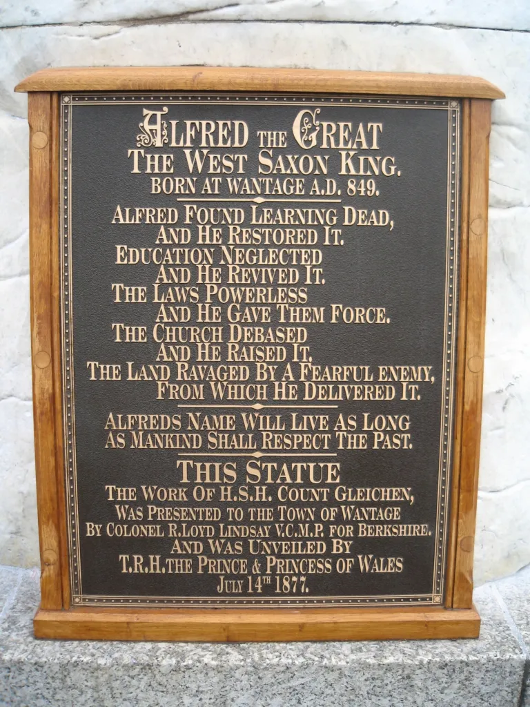 The bronze plaque on the statue's plinth recording its unveiling on 14 July 1877