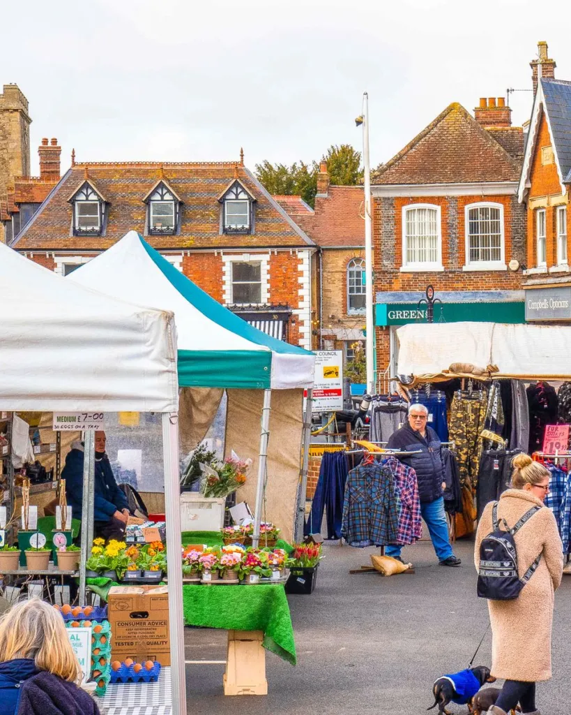 Market day in Wantage Market Place, with stalls in front of the Georgian shopfronts